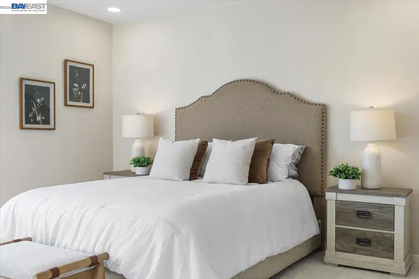 a bedroom with a bed and a lamp