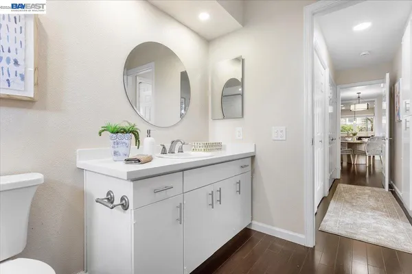 a en suite bathroom with a double vanity sink and a mirror