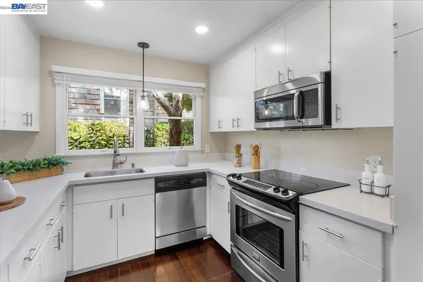 a kitchen with a sink stove and microwave