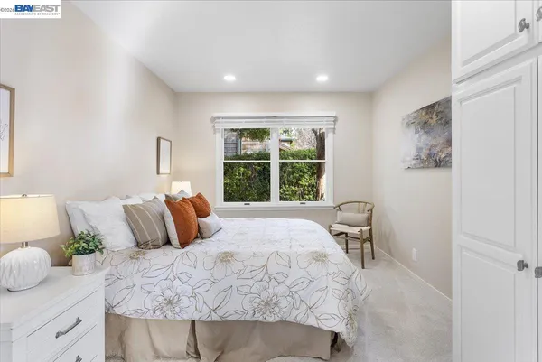 a bedroom with a large bed and a window