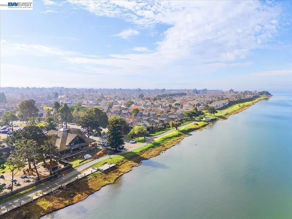 a view of a swimming pool with a yard and lake view