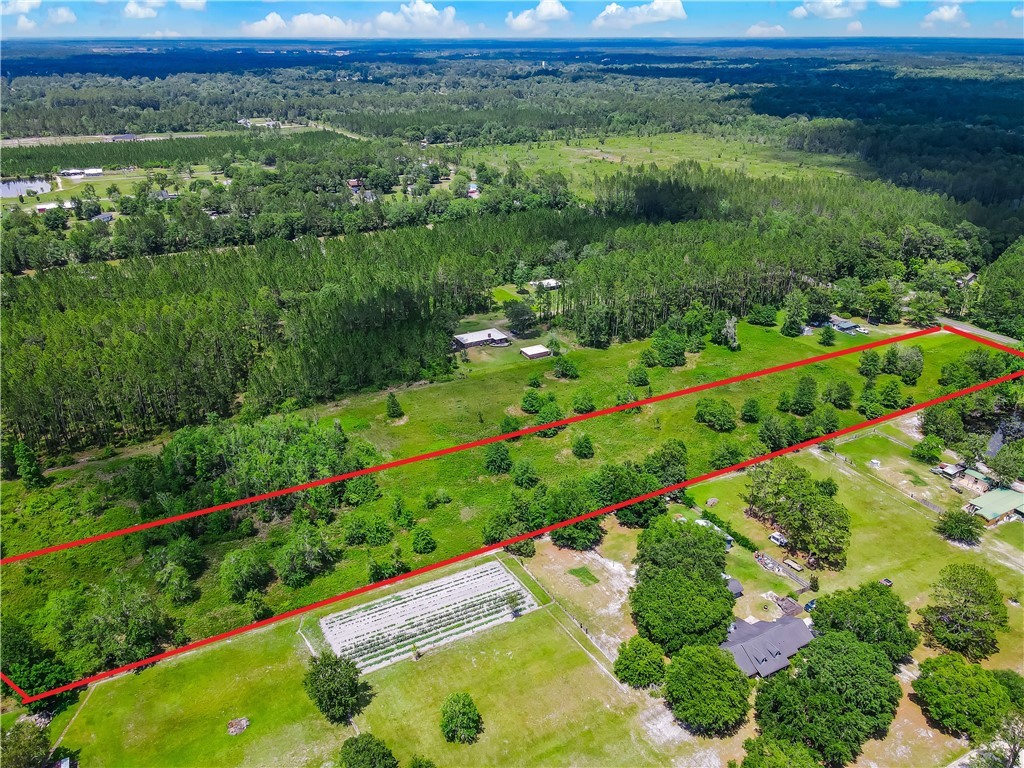 108 County Road Hilliard, FL 32046 - Photo 2 of 16 a view of a garden with a building in the background