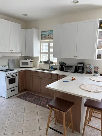 a kitchen with a sink a stove a microwave and cabinets