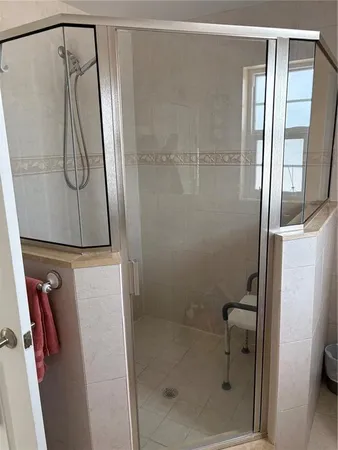 a bathroom with a glass shower door