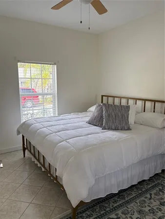 a bedroom with a bed and window