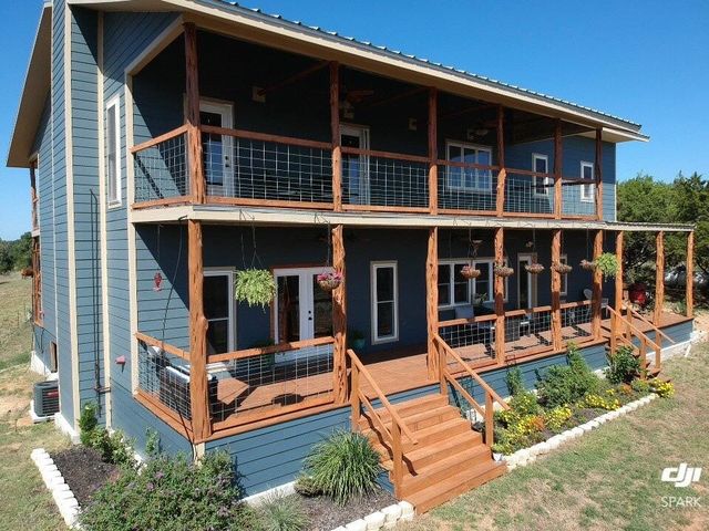 a view of a house with sitting area and garden