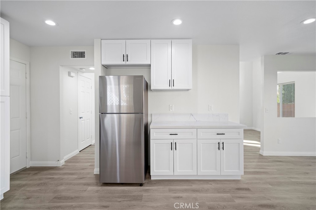 33034 Romero Drive Temecula, CA 92592 - Photo 11 of 21 a view of kitchen with refrigerator cabinet and wooden floor