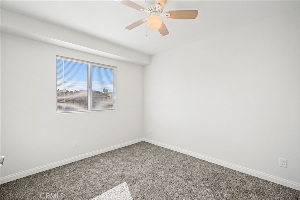 33034 Romero Drive Temecula, CA 92592 - Photo 14 of 21 an empty room with a window and a ceiling fan