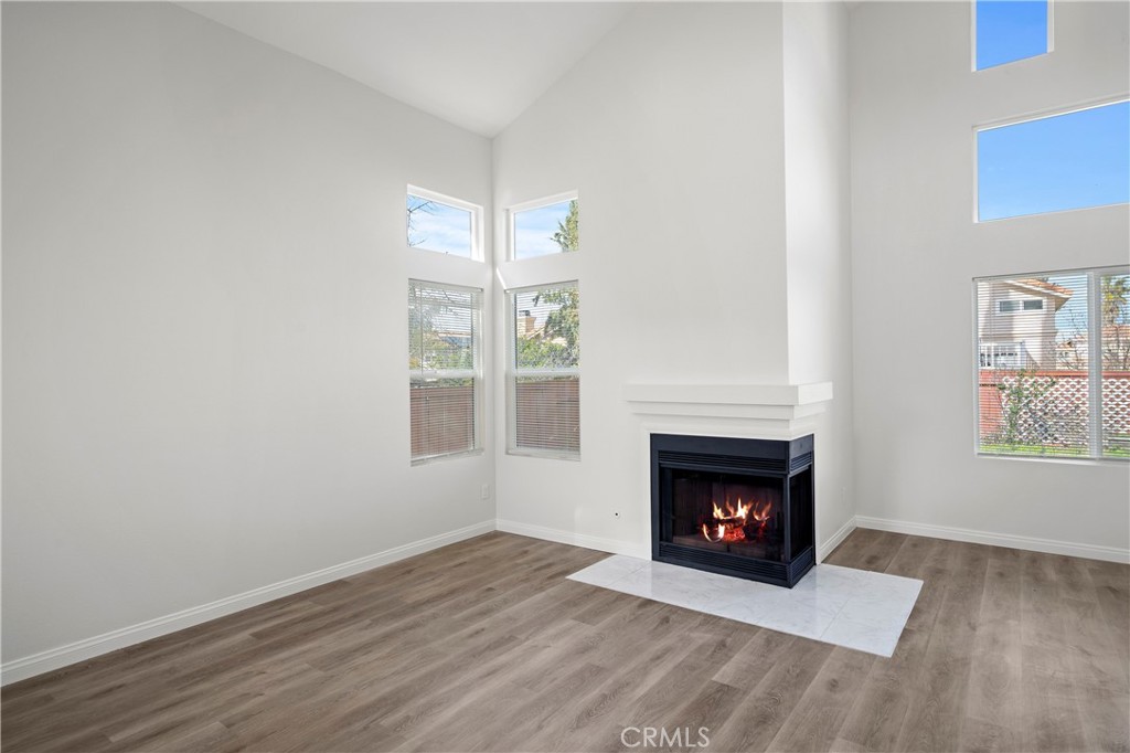 33034 Romero Drive Temecula, CA 92592 - Photo 2 of 21 a view of an empty room with wooden floor fireplace and a window