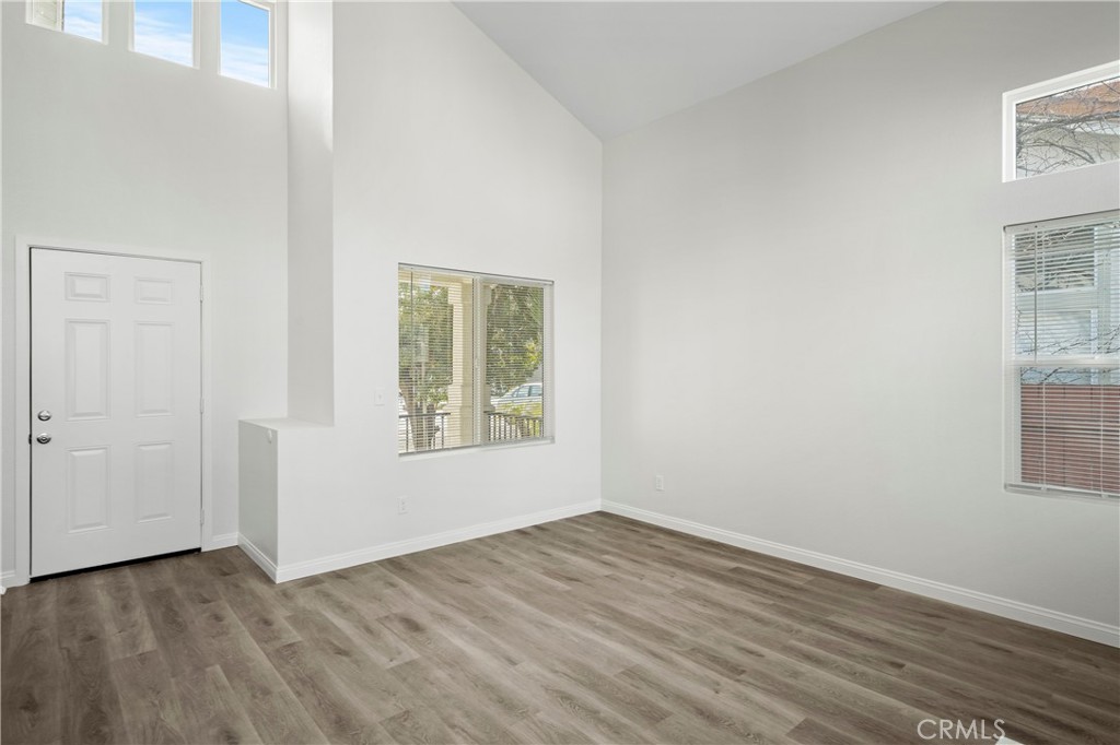 33034 Romero Drive Temecula, CA 92592 - Photo 5 of 21 an empty room with wooden floor and windows