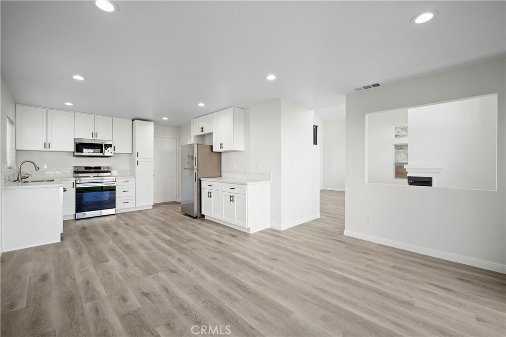 33034 Romero Drive Temecula, CA 92592 - Photo 8 of 21 a view of kitchen view wooden floor and window