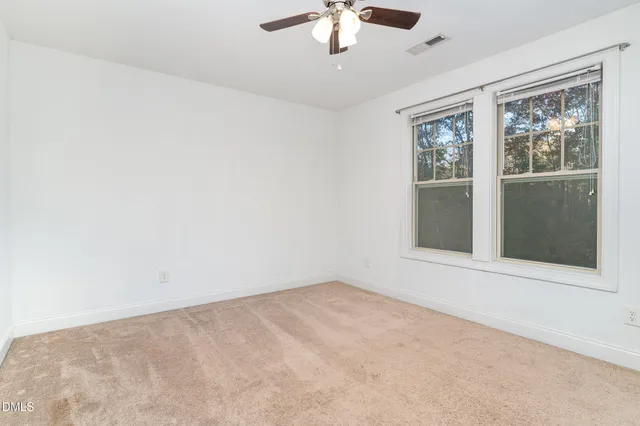 a bedroom with bed and window