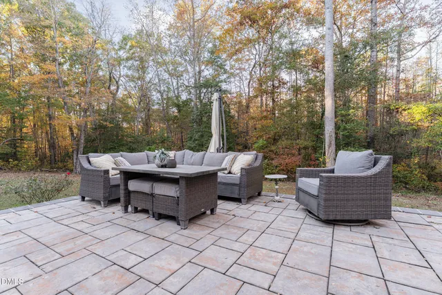 a backyard of a house with table and chairs