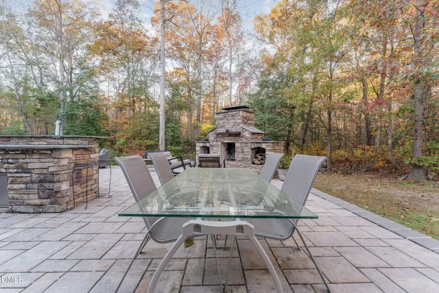 a backyard of a house with table and chairs