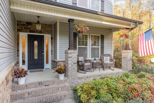 a front view of a house with outdoor seating and a garden