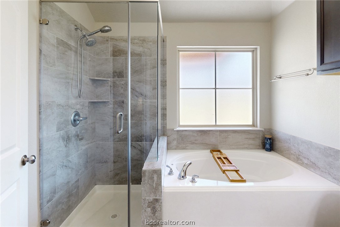 2071 Positano Loop Bryan, TX 77808 - Photo 17 of 31 a bathroom with a bath tub and a shower