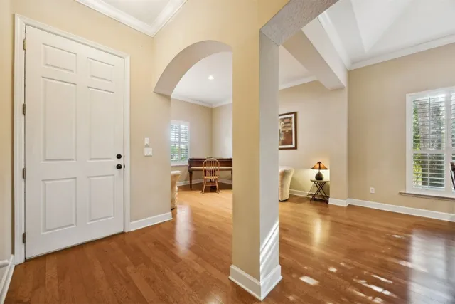 a kitchen with stainless steel appliances granite countertop white cabinets a window and a sink