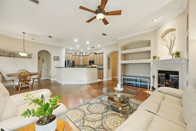 a spacious bedroom with a large bed and a chandelier
