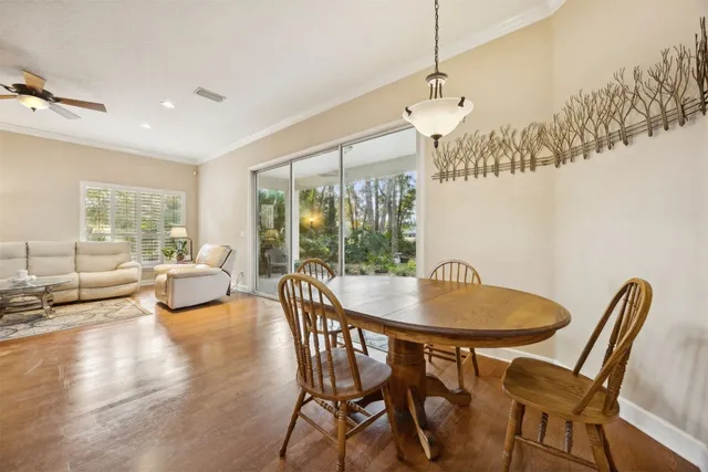 a view of a patio with table and chairs under an umbrella