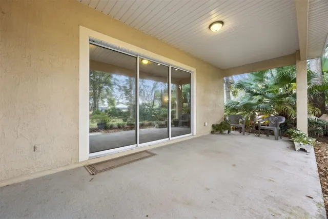an aerial view of a house with swimming pool patio and lake view