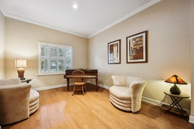 a dining room with furniture a chandelier and wooden floor