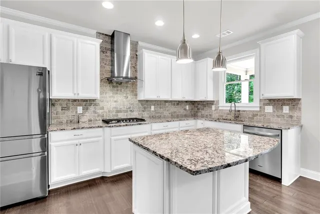a kitchen with stainless steel appliances granite countertop a sink stove and refrigerator
