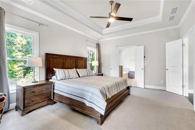 a bed room with a bed and a ceiling fan