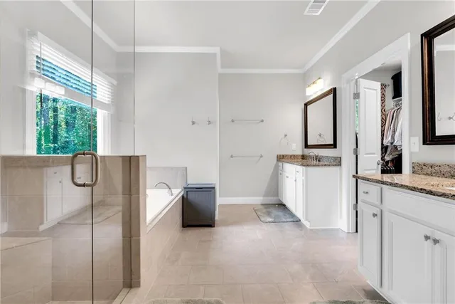 a spacious bathroom with a bathtub sink and mirror