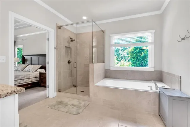 a bathroom with a tub shower and window