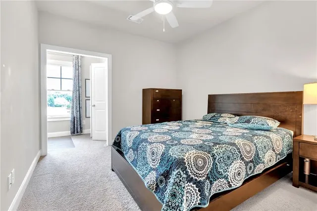 a bedroom with a large bed and a chandelier