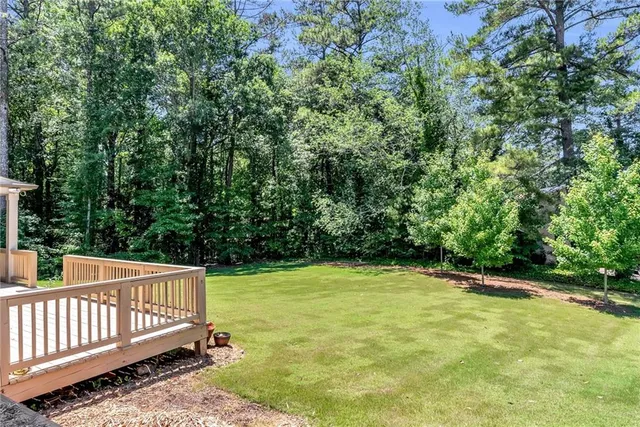 a view of a yard with wooden fence