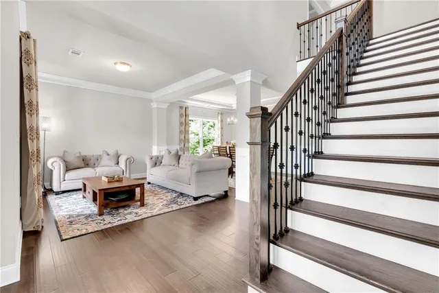 a living room with furniture and wooden floor