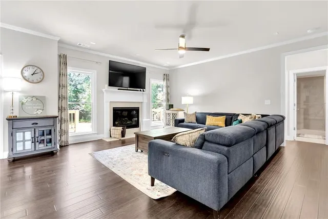 a living room with furniture flat screen tv and a fireplace