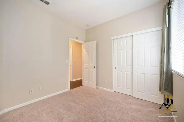 a view of a livingroom with a ceiling fan and window