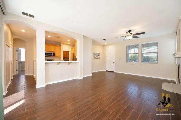 wooden floor in an empty room with a window