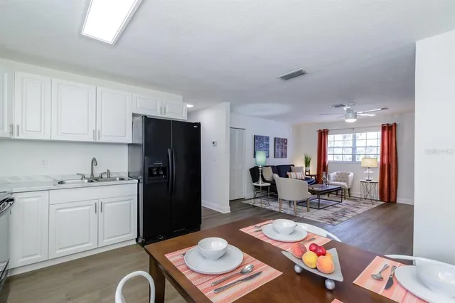 a kitchen with a refrigerator and a stove top oven