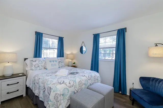 a bedroom with a bed couch and a window