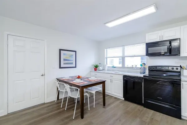 a kitchen with a table and chairs in it