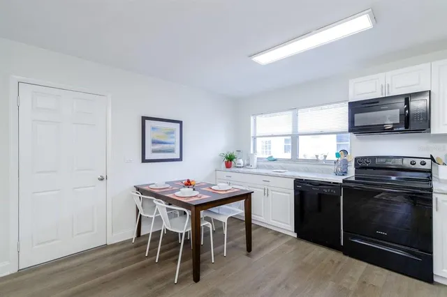 a kitchen with a table and chairs in it