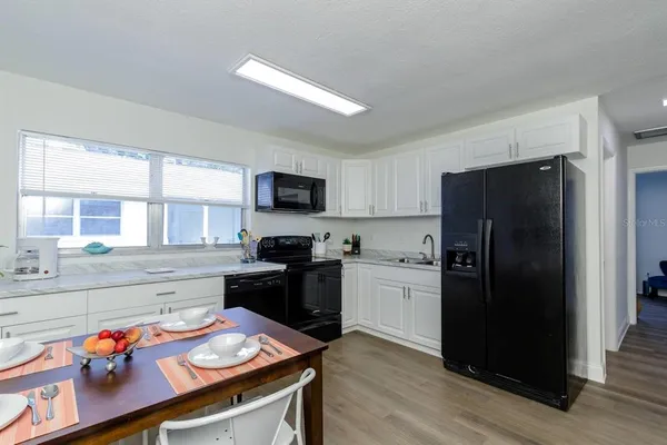 a kitchen with a refrigerator stove and sink