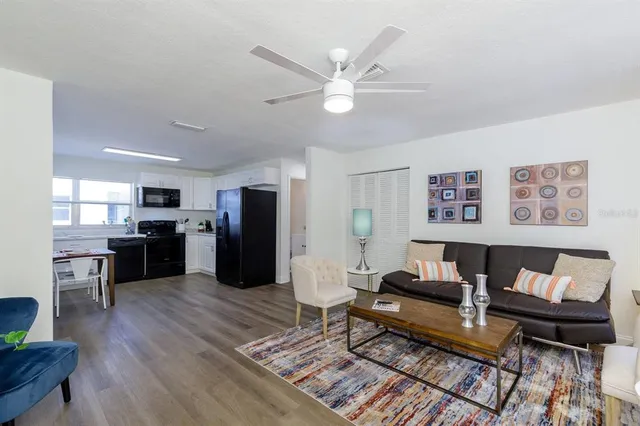 a living room with furniture and kitchen view