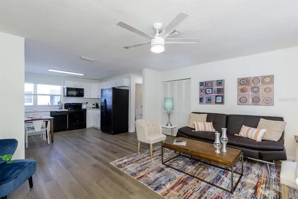a living room with furniture and kitchen view