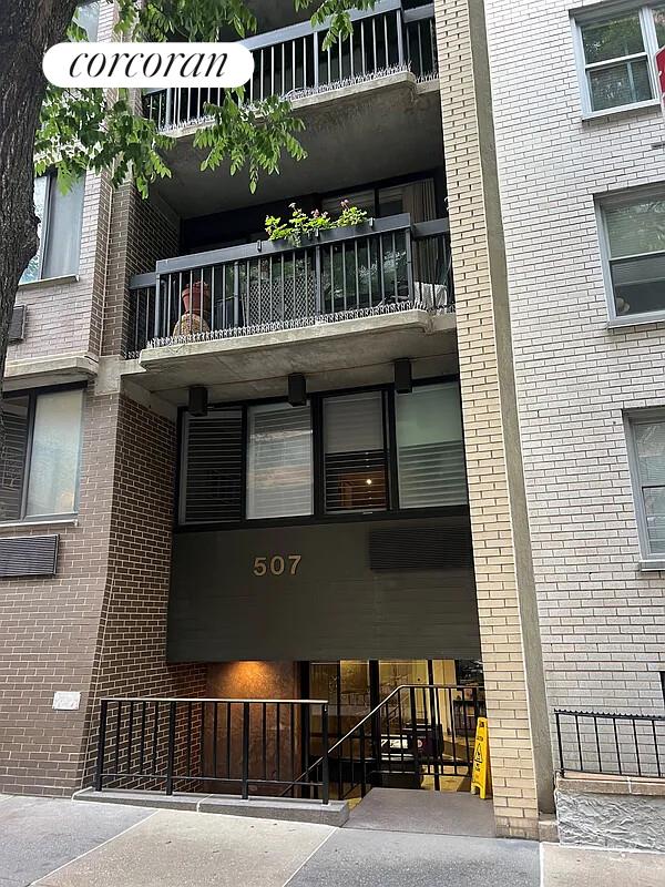 a view of a building with car parked