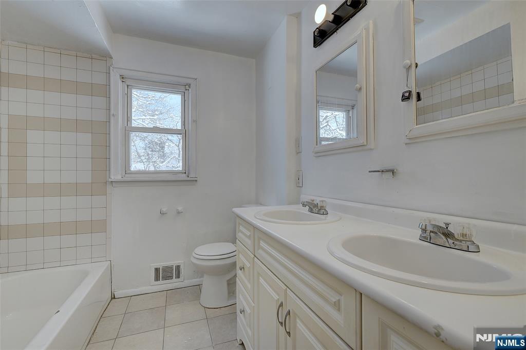 27 Old Short Hills Road West Orange, NJ 07052 - Photo 13 of 35 a bathroom with a sink toilet vanity and bathtub
