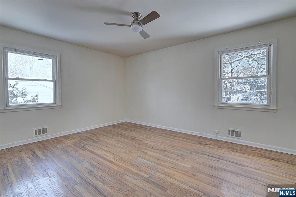 27 Old Short Hills Road West Orange, NJ 07052 - Photo 15 of 35 a view of empty room with wooden floor and fan