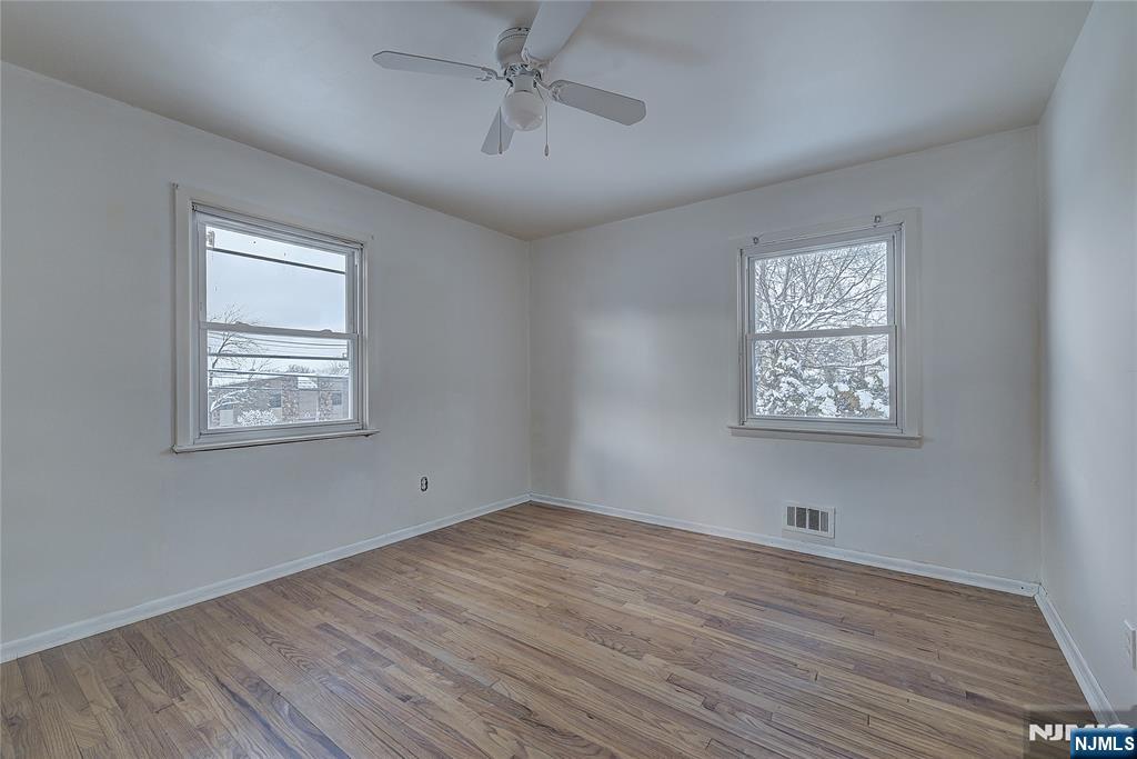 27 Old Short Hills Road West Orange, NJ 07052 - Photo 16 of 35 a view of empty room with wooden floor and fan