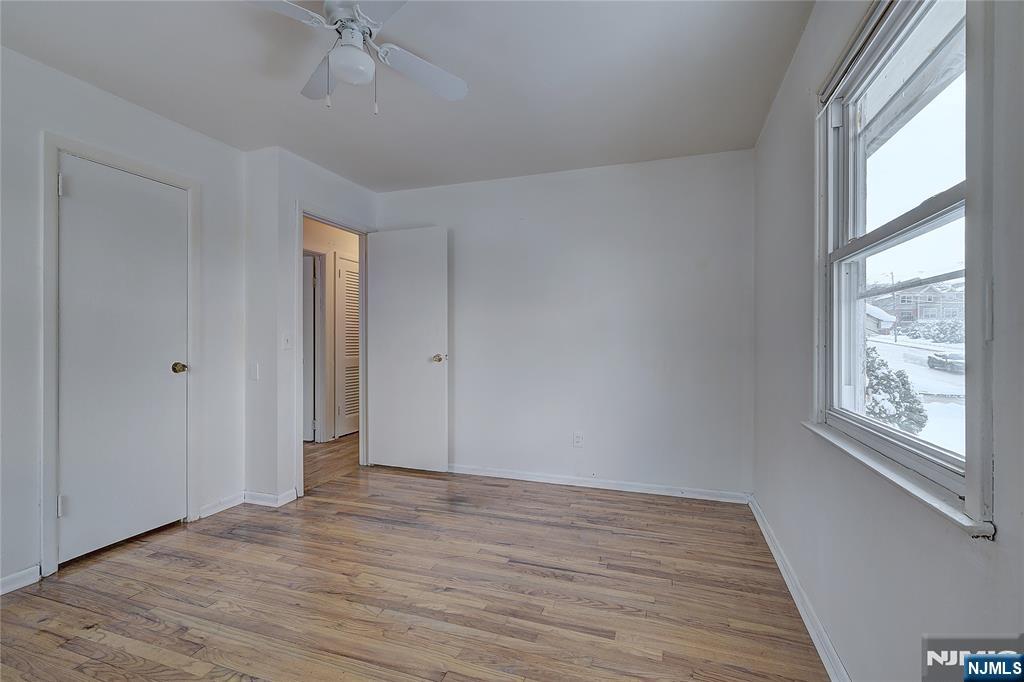 27 Old Short Hills Road West Orange, NJ 07052 - Photo 17 of 35 a view of an empty room with wooden floor and a window