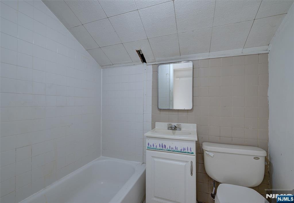 27 Old Short Hills Road West Orange, NJ 07052 - Photo 23 of 35 a white toilet sitting next to a bath tub