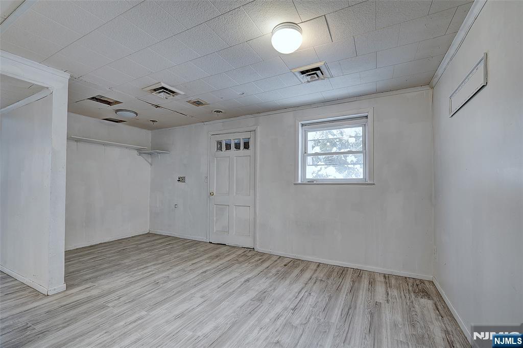 27 Old Short Hills Road West Orange, NJ 07052 - Photo 24 of 35 an empty room with wooden floor and windows