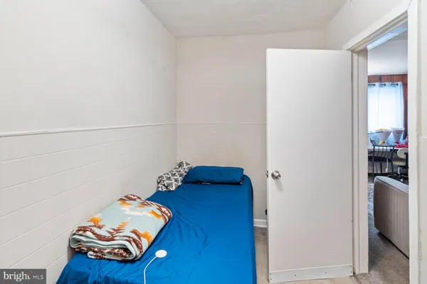 a bedroom with a bed and a couch